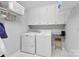 Bright laundry room with washer, dryer, and ample storage at 320 Belwood Dr, Belmont, NC 28012