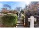 Stone steps leading to backyard with lush landscaping at 320 Belwood Dr, Belmont, NC 28012