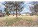 Spacious backyard with large tree and patio area at 3219 Monte Dr, Monroe, NC 28110