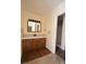 Bathroom with wood cabinets, laminate countertop and tile flooring, leading to a shower at 3303 Reid Cir, Monroe, NC 28112