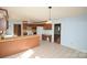 Cozy kitchen featuring tile floors, white appliances, wood cabinets and breakfast bar at 3303 Reid Cir, Monroe, NC 28112