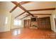 Spacious living room boasting hardwood floors, exposed beam ceiling, and a cozy brick fireplace at 3303 Reid Cir, Monroe, NC 28112