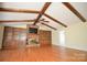 Bright living room featuring a brick fireplace, built-in shelves, and hardwood floors at 3303 Reid Cir, Monroe, NC 28112