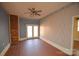 Living room featuring brick accent wall, tiled flooring, and natural light from the back patio at 3303 Reid Cir, Monroe, NC 28112