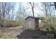 Outdoor storage shed in backyard, surrounded by mature trees and foliage at 3303 Reid Cir, Monroe, NC 28112