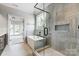 Bright bathroom featuring soaking tub and glass shower with tile surround at 3428 Greene Rd, Monroe, NC 28110