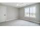 Bright bedroom with large window and neutral carpeting and ceiling fan at 3428 Greene Rd, Monroe, NC 28110