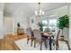 Elegant dining area featuring hardwood floors, modern lighting, and a cozy ambiance at 3428 Greene Rd, Monroe, NC 28110