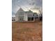 Two-story home with gray and beige siding, covered porch, and unfinished yard at 3428 Greene Rd, Monroe, NC 28110