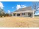 Backyard view of home with covered patio perfect for outdoor entertaining at 3428 Greene Rd, Monroe, NC 28110