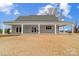 Rear exterior view of home with large, covered patio and expansive lawn at 3428 Greene Rd, Monroe, NC 28110