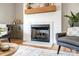 Living room with a modern fireplace, wood mantle, and seating for a cozy and inviting atmosphere at 3428 Greene Rd, Monroe, NC 28110