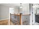 Hallway with wooden railing and floors leading to bedrooms at 3428 Greene Rd, Monroe, NC 28110