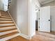 Hallway with wooden stairs leading to a bathroom at 3428 Greene Rd, Monroe, NC 28110