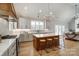 Stylish kitchen featuring a central island, wooden stools, and stainless steel appliances, with seamless living area access at 3428 Greene Rd, Monroe, NC 28110