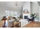 Bright living room with a modern fireplace, hardwood floors, and comfortable seating at 3428 Greene Rd, Monroe, NC 28110