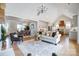 Open-concept living room showcasing hardwood floors, a modern chandelier, and seamless flow into the kitchen and dining area at 3428 Greene Rd, Monroe, NC 28110