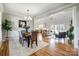 Open concept living space with hardwood floors, connecting dining and living areas at 3428 Greene Rd, Monroe, NC 28110