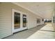 Covered back patio featuring double doors and traditional trim at 3428 Greene Rd, Monroe, NC 28110