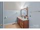 Bathroom with wood vanity and light blue walls at 36190 Millingport Rd, New London, NC 28127