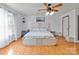 Bright bedroom featuring hardwood floors and ceiling fan at 36190 Millingport Rd, New London, NC 28127