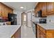 Kitchen features wood cabinets, granite countertops, and black appliances at 36190 Millingport Rd, New London, NC 28127