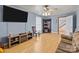 Living room with hardwood floors and a large TV at 36190 Millingport Rd, New London, NC 28127