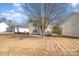 Two-story home with backyard, tree, and winter grass at 3821 Bullard St, Charlotte, NC 28208