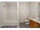 Updated bathroom with tub/shower combo and wood vanity at 3821 Bullard St, Charlotte, NC 28208