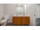 Bathroom with double sinks and wood cabinets at 3821 Bullard St, Charlotte, NC 28208