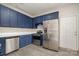 Kitchen with stainless steel appliances and blue cabinets at 3821 Bullard St, Charlotte, NC 28208