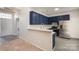 Kitchen with stainless steel appliances and blue cabinets at 3821 Bullard St, Charlotte, NC 28208