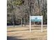 White sign marking the entrance to Pitcairn Park at 4066 Triton Dr, Tega Cay, SC 29708