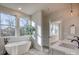 Bright bathroom featuring a freestanding tub and double sinks at 4827 Brookridge Ne Dr, Hickory, NC 28601