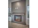 Modern electric fireplace with a rustic wood mantel at 4827 Brookridge Ne Dr, Hickory, NC 28601