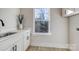 Laundry room with white cabinets, quartz countertops, and a window at 4827 Brookridge Ne Dr, Hickory, NC 28601