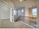 Upstairs hallway with a staircase and access to other rooms at 4827 Brookridge Ne Dr, Hickory, NC 28601