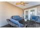 Covered back porch with wicker furniture and ceiling fan at 489 Maple Ridge Cir, Salisbury, NC 28147