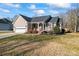 Tan house with gray roof, attached garage, and a front porch at 489 Maple Ridge Cir, Salisbury, NC 28147