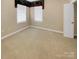 Spacious bedroom with neutral carpeting and two windows at 5573 Prosperity View Dr, Charlotte, NC 28269