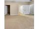 Bright bedroom with multiple doors and neutral carpeting at 5573 Prosperity View Dr, Charlotte, NC 28269