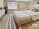 Virtually staged main bedroom with light and airy feel at 5573 Prosperity View Dr, Charlotte, NC 28269