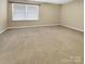 Simple bedroom with neutral walls and carpet at 5573 Prosperity View Dr, Charlotte, NC 28269