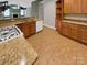 Kitchen features granite counters, wood cabinets and a gas cooktop at 5573 Prosperity View Dr, Charlotte, NC 28269