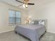 Cozy bedroom featuring carpet, a ceiling fan, and a bed with decorative pillows, perfect for relaxation at 5904 Bryant Ln, Waxhaw, NC 28173