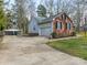 Side view of home featuring brick and siding, a two-car garage, and a carport at 5904 Bryant Ln, Waxhaw, NC 28173