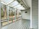 Enclosed porch with wood flooring, screened windows, and natural light at 5904 Bryant Ln, Waxhaw, NC 28173