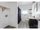 Updated bathroom with patterned floor and shelf at 604 E Louisiana Ave, Bessemer City, NC 28016