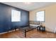 Bedroom with dark blue walls and wood floors at 604 E Louisiana Ave, Bessemer City, NC 28016