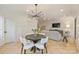 Open-concept living and dining area with a modern chandelier and hardwood floors at 6133 Berryhill Towns Dr, Charlotte, NC 28270